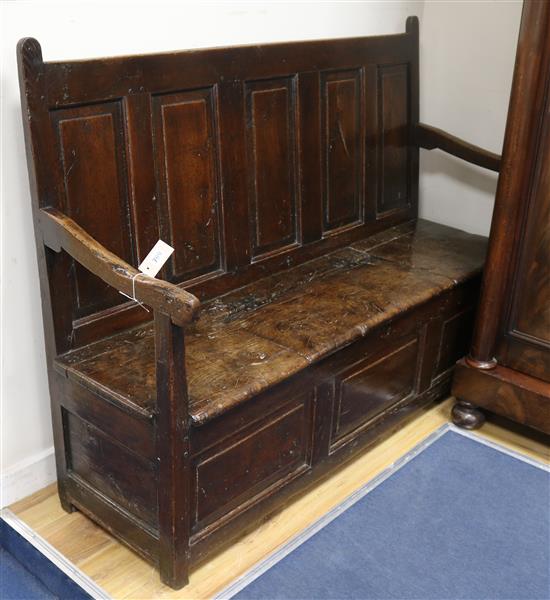 A 17th century oak box settle W.153cm